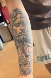 Black and Gray Tattoo of Jesus on the outer forearm
