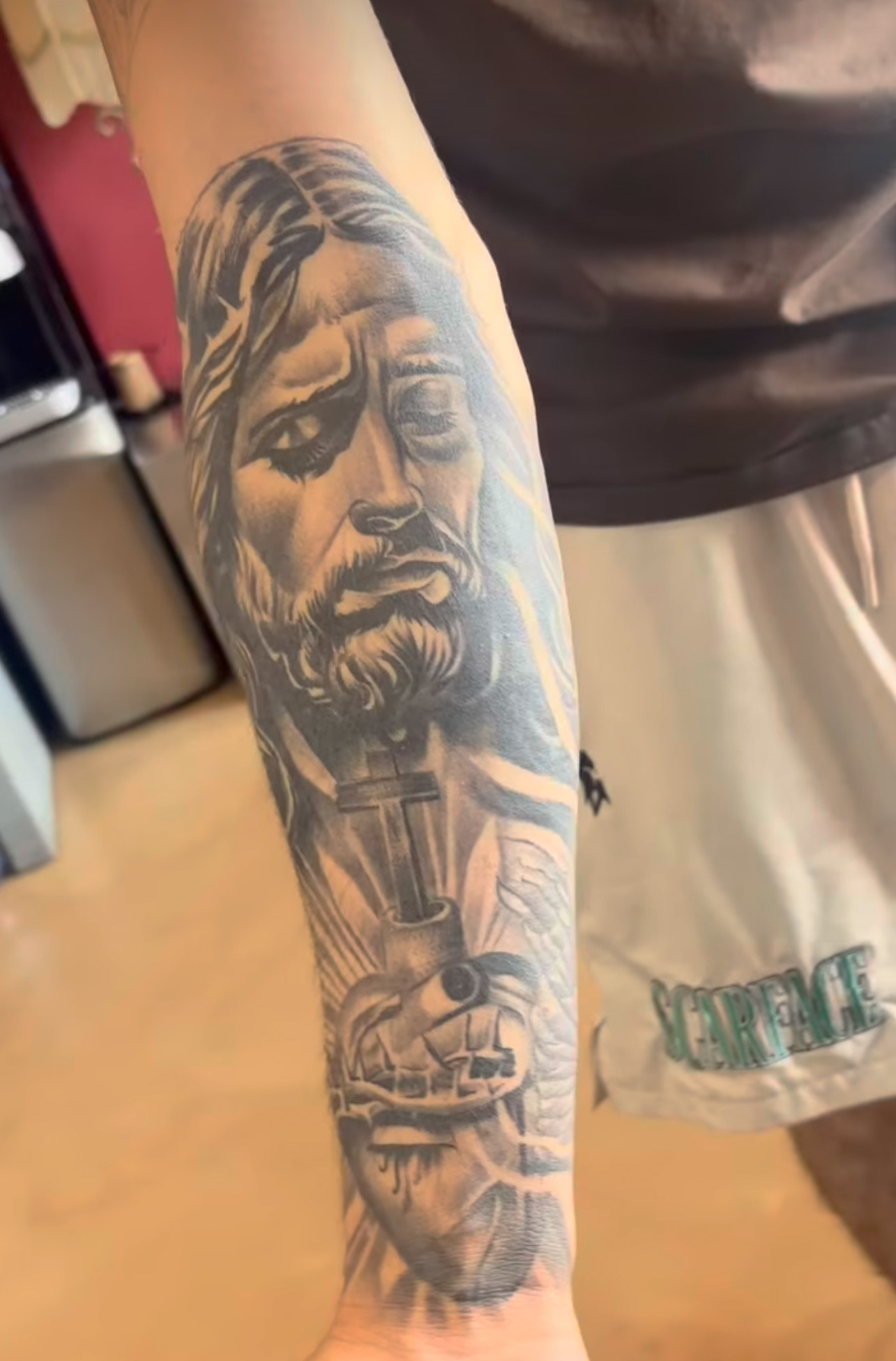 Black and Gray Tattoo of Jesus on the outer forearm