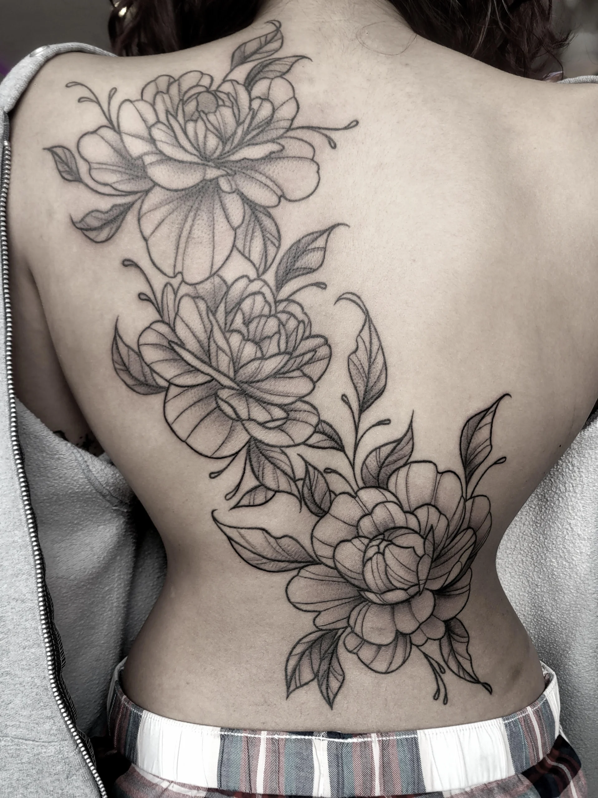 Large floral back-piece tattoo by Jasmine at Broken Clover Tattoo in Tucson