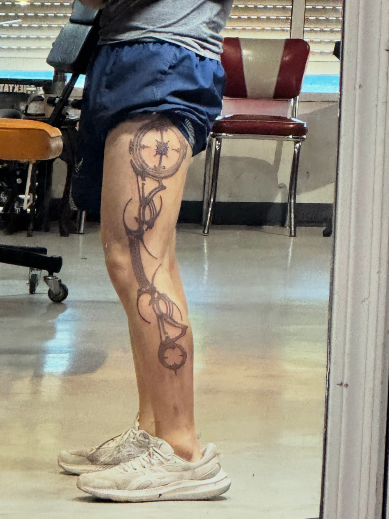 Upper thigh extending to mid calf tattoo