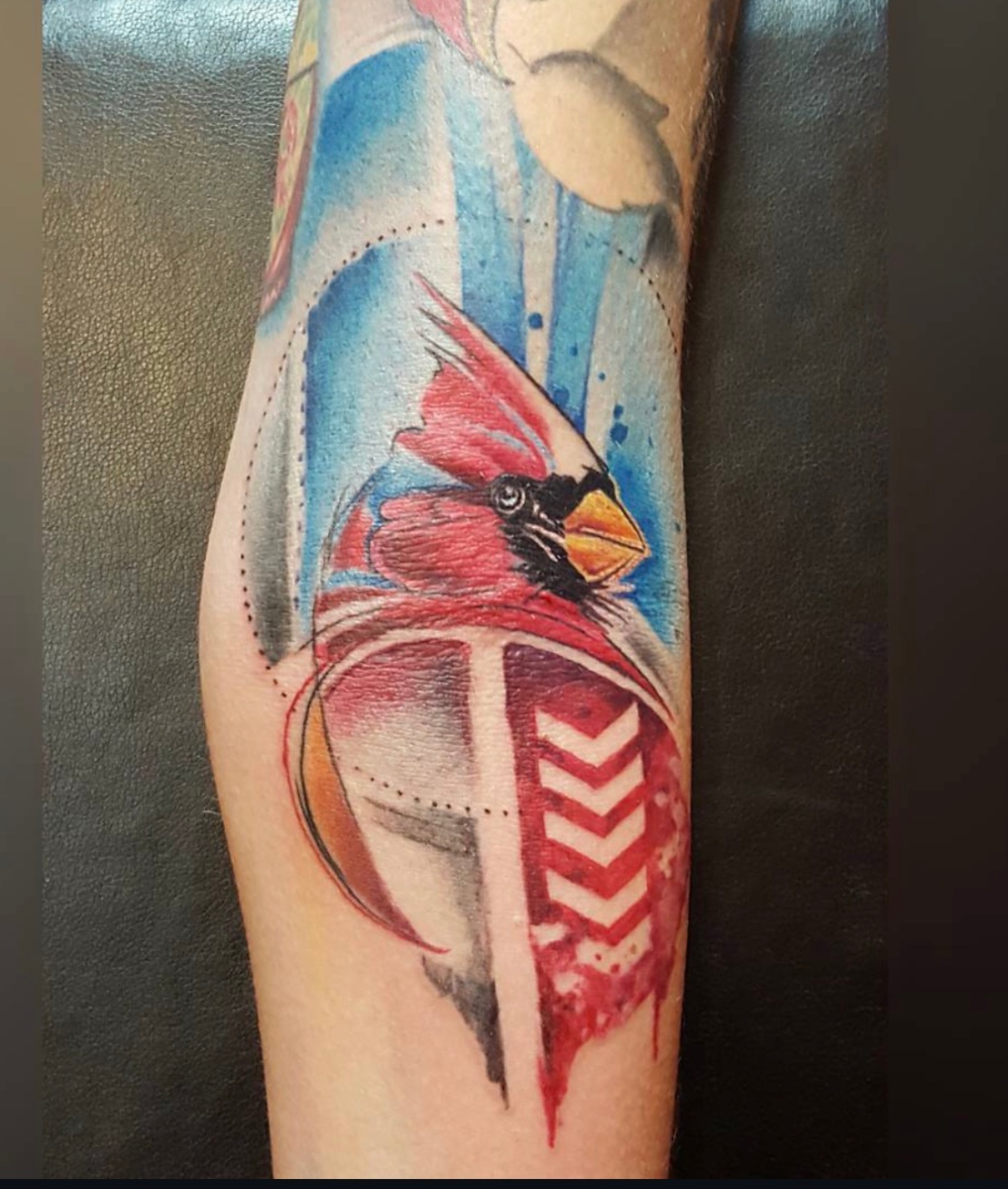 Watercolor-style cardinal tattoo by Jinx at Broken Clover Tattoo in Tucson