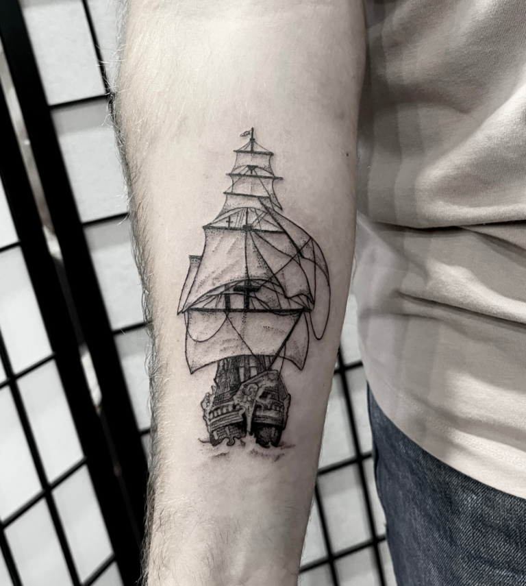 A blackwork pirate ship tattoo